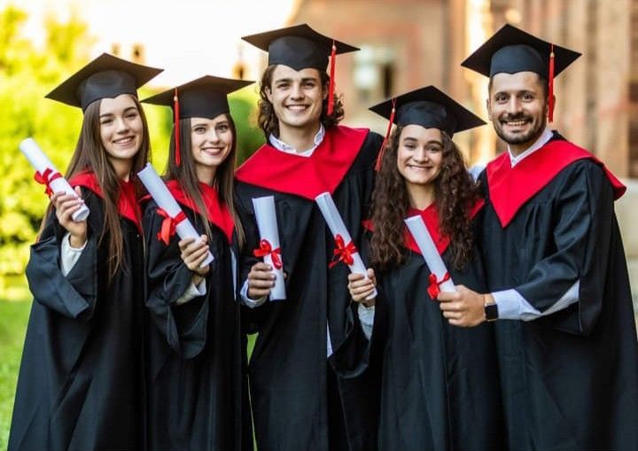 Students celebrating admissions success together outdoors