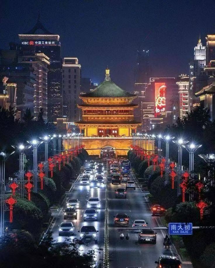 Night view of a Chinese city skyline with bright lights by the river